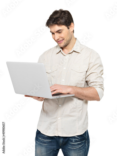 Photo: Portrait of young man with laptop in casuals Portrait of young man with laptop in casuals