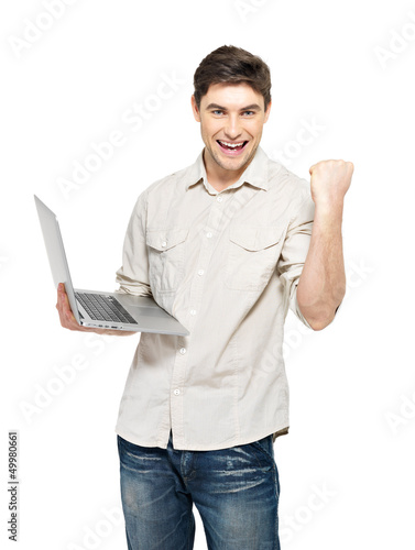 Photo: Portrait of young man with laptop in casuals Portrait of young man with laptop in casuals