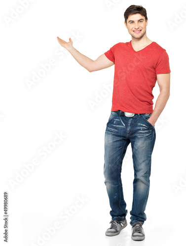 Photo: Full portrait of a smiling man shows something Full portrait of a smiling man shows something