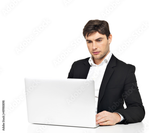 Photo: office worker with laptop sitting on the table office worker with laptop sitting on the table