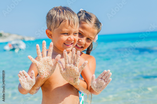Photo: Girl and boy On Sand Girl and boy On Sand
