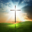 Christian cross on grassy background.
