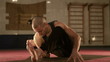 Young man in a Yoga lotus position in the port Gym