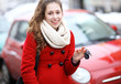 Young woman showing car key