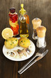 Dish of herring and spices on wooden table close-up