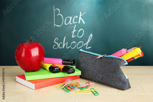 Photo: Back to school - blackboard with pencil-box and school Back to school - blackboard with pencil-box and school