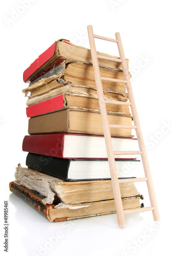 Photo: Old books and wooden ladder, isolated on white Old books and wooden ladder, isolated on white