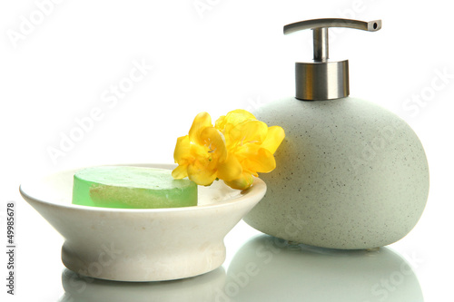Photo: Bottle and soap-dish with soap isolated on white Bottle and soap-dish with soap isolated on white