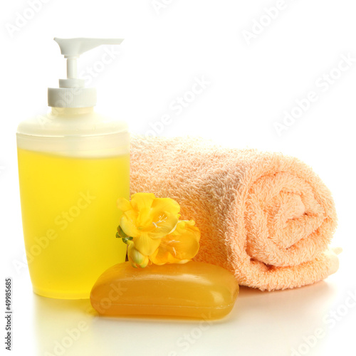 Photo: Bottle, soap and towel, isolated on white Bottle, soap and towel, isolated on white