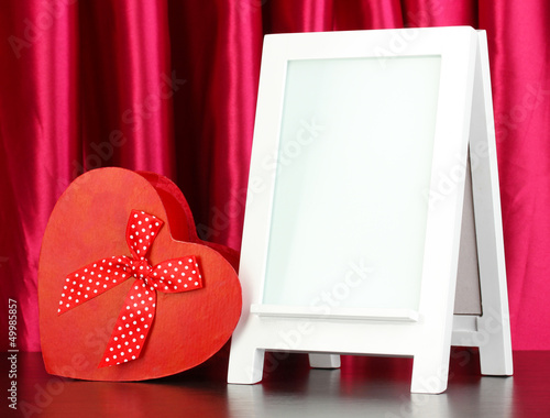 Photo: White photo frame for home decoration on curtains background White photo frame for home decoration on curtains background