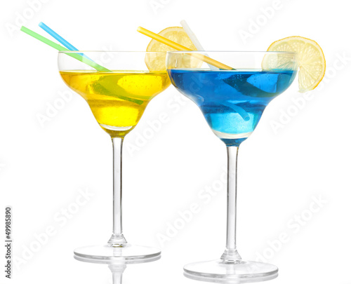 Photo: Yellow and blue cocktails in glasses isolated on white Yellow and blue cocktails in glasses isolated on white