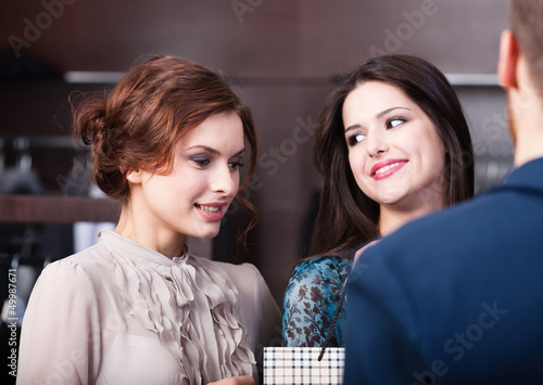 Photo: Two wonderful women talk to shop assistant Two wonderful women talk to shop assistant