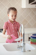 Little girl washing the dishes