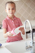 Little girl washing the dishes