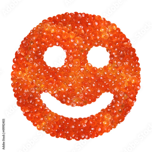 Photo: Red caviar in the form of a smile on a white background Red caviar in the form of a smile on a white background