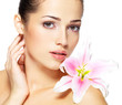 Beauty face of young woman with flower. Beauty treatment concept
