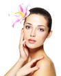 Beauty face of young woman with flower. Beauty treatment concept