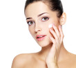 Beauty face of young woman with cosmetic cream on a cheek.