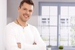 Portrait of handsome young man by window