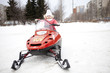 Children are riding on snowmobiles.