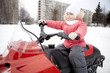 Children are riding on snowmobiles.