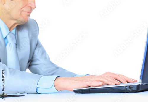 Photo: The businessman at the age of works for the laptop. The businessman at the age of works for the laptop.