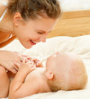 Photo: Mother and daughter play in the bedroom Mother and daughter play in the bedroom