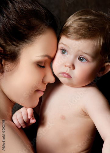 Photo: Young mother hugging baby Young mother hugging baby