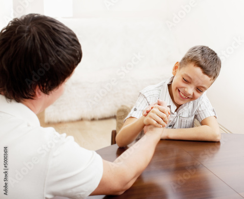 Photo: Father and son arm wrestling Father and son arm wrestling