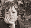 A sad, young boy looking into the camera