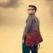 handsome hipster guy with a bag. vintage photo
