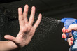 The spray pours water on a hand