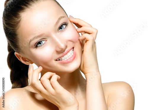 Photo: Beautiful Young Woman with Fresh Clean Skin touching her Face Beautiful Young Woman with Fresh Clean Skin touching her Face