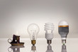 evolution of lighting, with candle, tungsten, fluorescent and LE