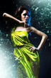 slim sexy woman in green dress and shuttered glass