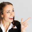 Businesswoman showing, over gray