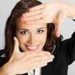 Businesswoman framing her face with hands