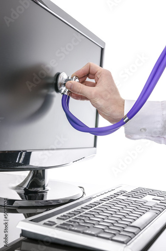 Photo: Serviceman testing a computer with stethoscope Serviceman testing a computer with stethoscope