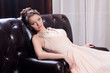 woman in a long sitting on the couch