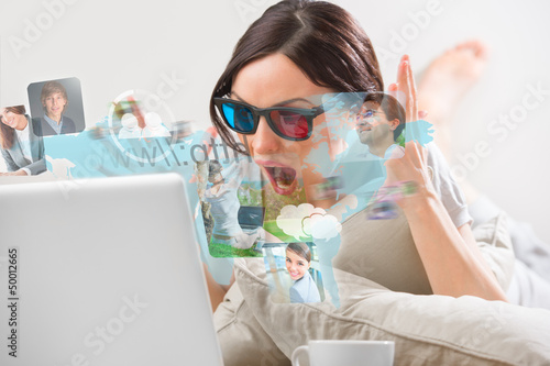 Photo: Pretty woman surfing on web with modern laptop Pretty woman surfing on web with modern laptop