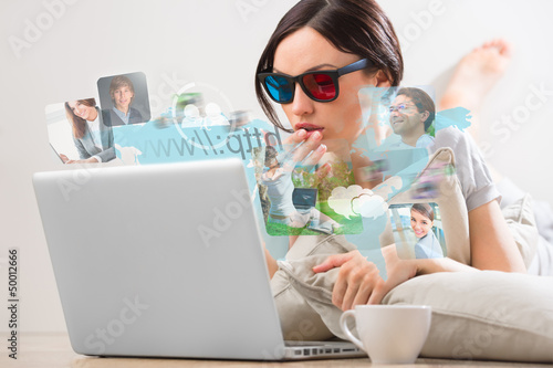 Photo: Pretty woman surfing on web with modern laptop Pretty woman surfing on web with modern laptop