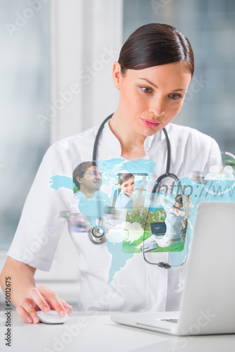 Photo: Female medical doctor surfing on web with modern laptop Female medical doctor surfing on web with modern laptop
