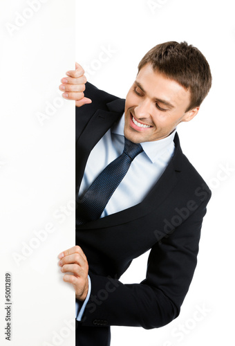 Photo: Businessman showing blank signboard, isolated Businessman showing blank signboard, isolated