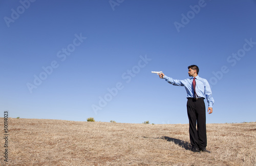Photo: Businessman aiming a handgun Businessman aiming a handgun