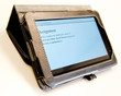 Tablet computer propped horizontally in a leather case