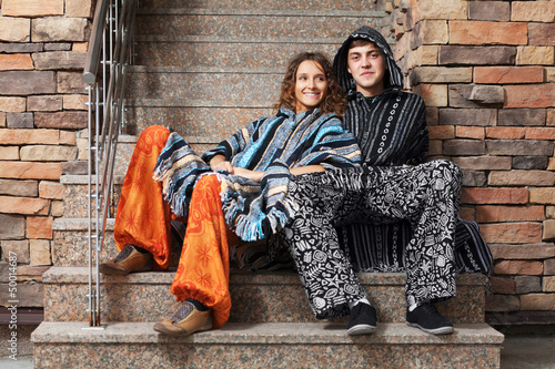 Photo: Young hippie couple sitting on the steps Young hippie couple sitting on the steps