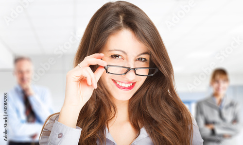 Photo: Beautiful woman holding her eyeglasses Beautiful woman holding her eyeglasses