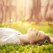 beautiful girl relaxing lying on the grass in the garden