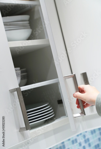 Photo: Opening kitchen cabinet door Opening kitchen cabinet door