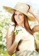 Photo: Spring woman in summer dress walking in park enjoying the sun. Spring woman in summer dress walking in park enjoying the sun.